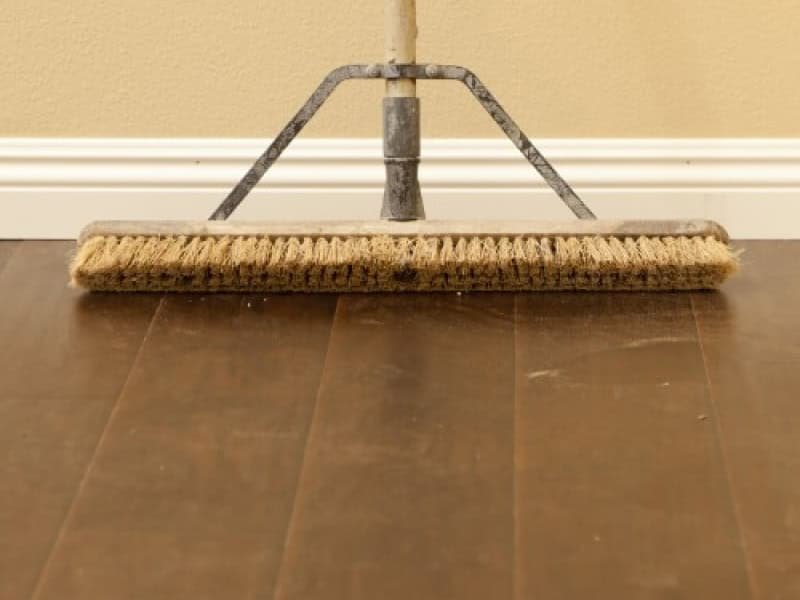 hardwood with broom | Haley's Flooring & Interiors